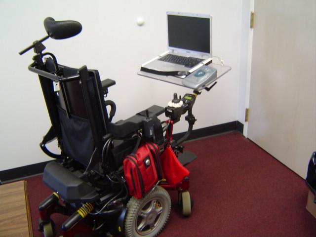 Image of Power wheelchair with laptop and trackball mounted on tubing