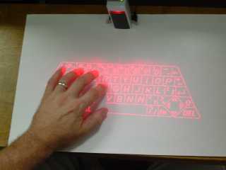 Virtual red laser keyboard projected on a desktop